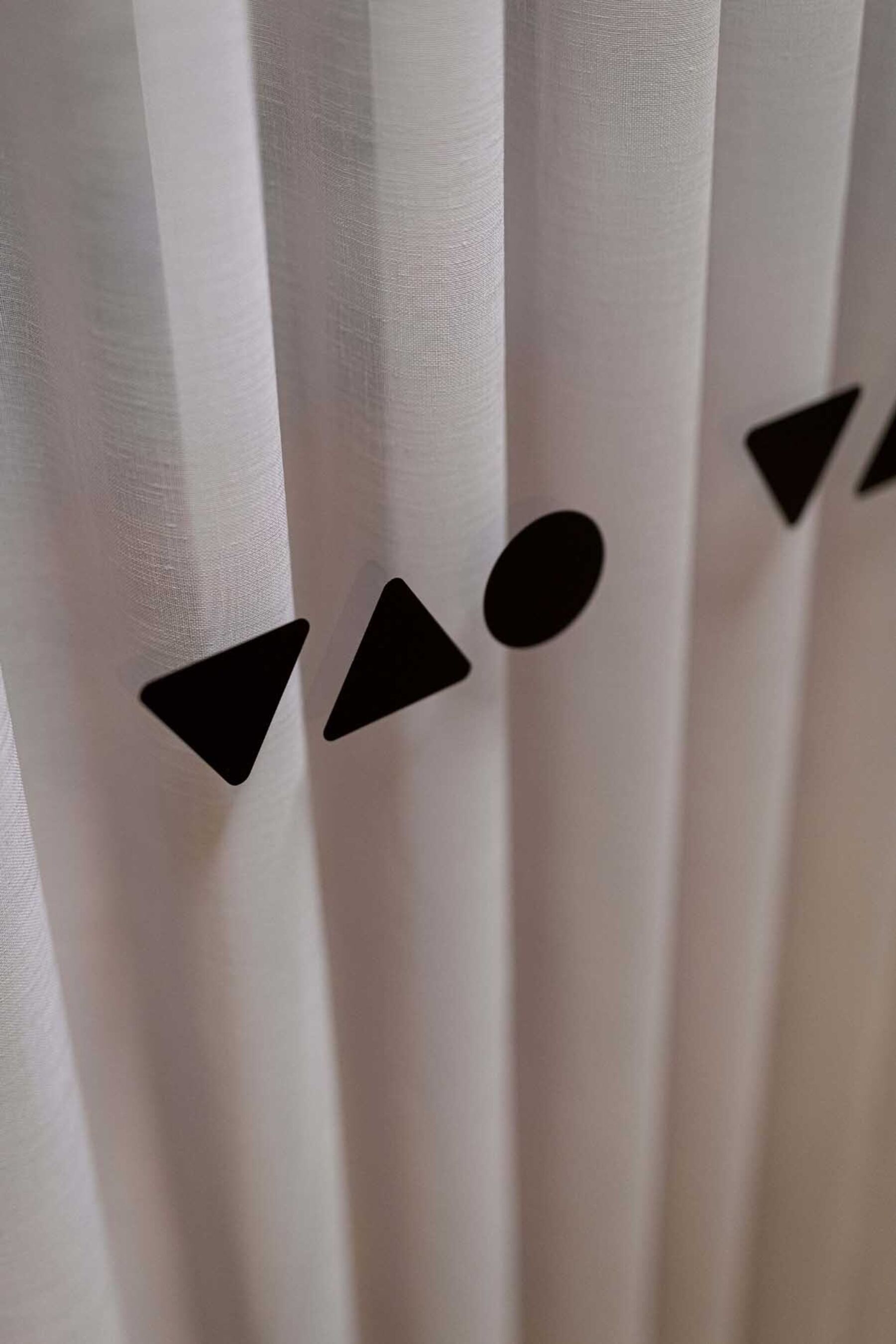 Detaljbilde av ikoner printet på en glassvegg. Foto.